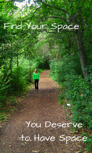 woman standing on wooded trail